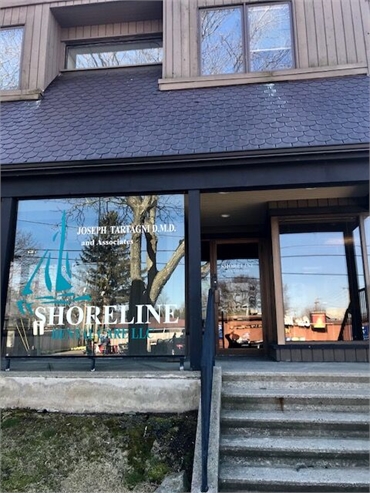 Signage on the glass panel at Shoreline Dental Care Milford CT