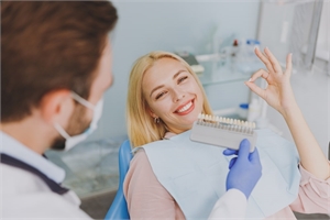 dentist showing dental veneers to patient
