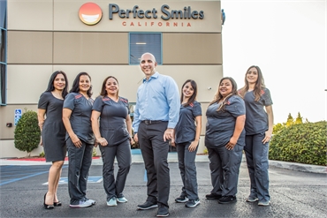 The team at Chula Vista dentist Perfect Smiles California with the office building in the background