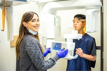 Dental hygienist help patient with 3D-Ct Cone Beam Imaging procedure at Chula Vista dentist Perfect 