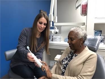 Dental hygienist talking to teeth cleaning patient at Fishers dentist Holt Dental