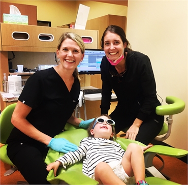 pediatric dentist giving child dental exam