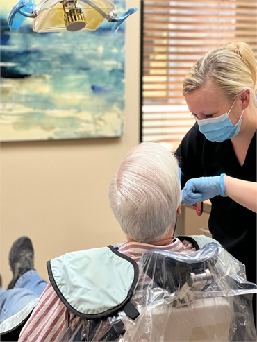 Dental hygienist works with dental implants patient at Cereus Dental Care Tempe AZ