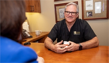 Dallas dentist Dr. Brock Lynn explaining the benefits of nightguard at Lynn Dental Care