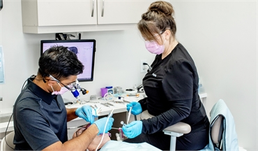 Barrie dentist Dr. Gomes performing dental implants procedure at Dentistry By The Bay