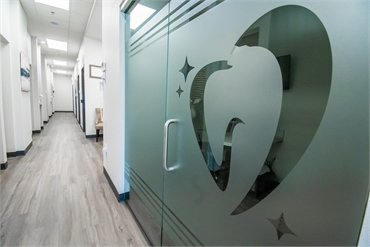 Logo signage on the glass door of the consulting room at Starlite Dental McKinney