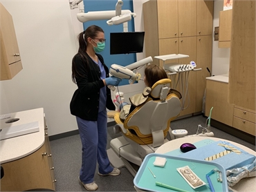 Dental hygienist with patient at Fayetteville dentist McQueen Dental