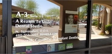 Signage on the glasspane at Scottsdale dentist A Reason to Smile