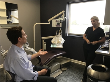 North Canton dentist Dr. Danner discussing case with staff at Danner Dental