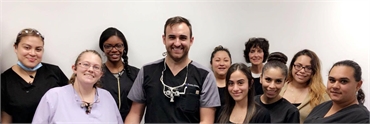Aurora IL dentist Dr Goetz with staff at Smiles of Aurora