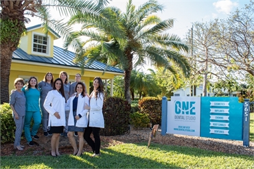Dental team against the backdrop of the building exterior of One Dental Studio