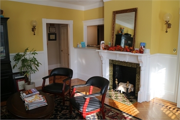 Cozy waiting area and fireplace at Essex Street Dental Medicine