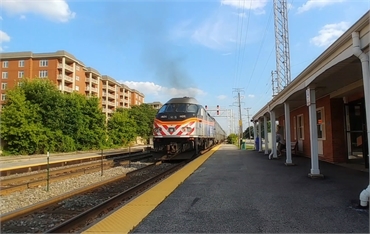 Metra train departing from Morton Grove station at 5 minutes drive to the southwest of Advanced Dent