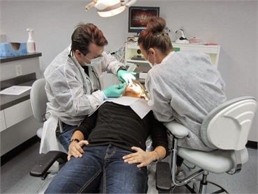 Patient receiving dental treatment with  Palm Beach Gardens FL dentist Andrew Rudnick DMD