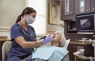 Family dentist checking teeth at Dental Health Care of Woburn P.C.