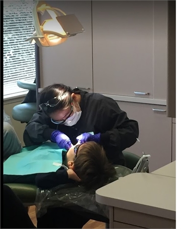 Seattle Pediatric dentist at work at Fidler On The Tooth
