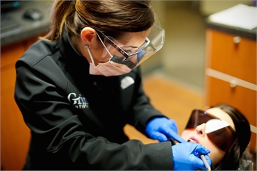 Fishers Dentist Dr. Mundy Burgett providing dental exam Grin Dentistry