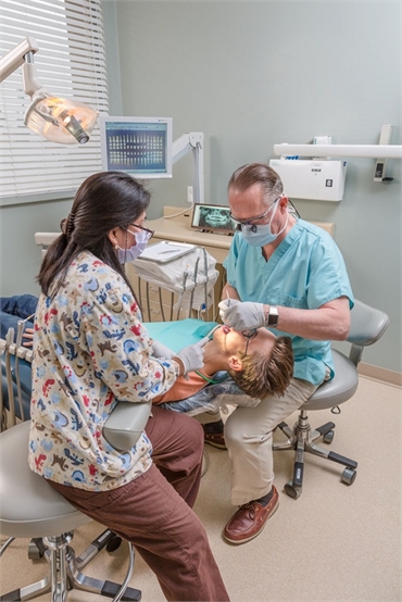 Anchorage dentist Dr. Stephen Maloney working with patient