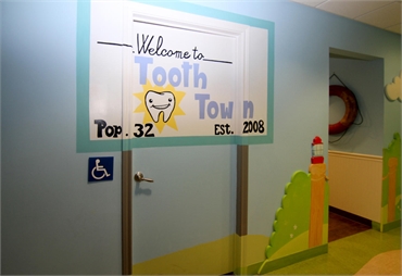 City welcome signage themed operatory entrance at Smiles of Austin