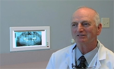 Orthodontist Dr. Steven Reeves explaining various options wiith patient