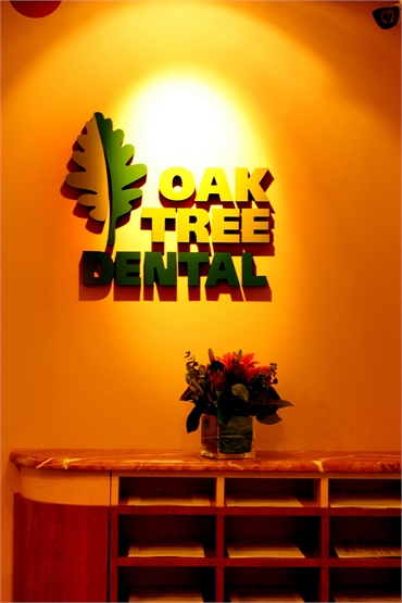 Oak Tree Dental logo on the main wall facing entrance
