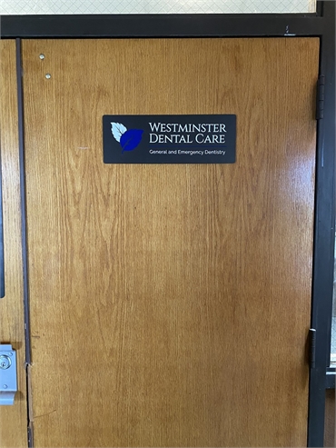 Signage on the entrance door at Westminster Dental Care